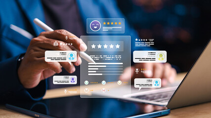 Fototapeta premium Businessman using stylus and laptop with digital rating interface showing stars and feedback. Concept of satisfaction, review and reputation.