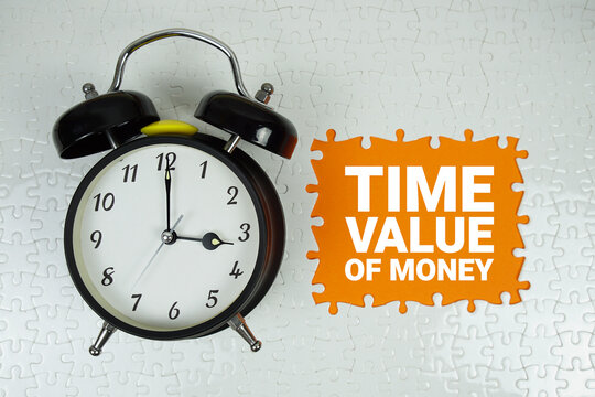 Time Value of Money text with alarm clock on orange background