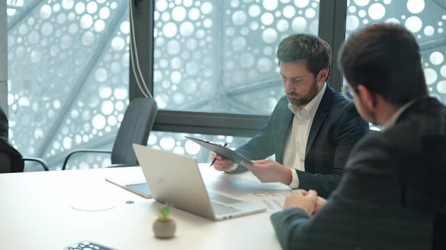 Corporate professionals conclude successful business meeting, expressing satisfaction, trust, finalizing deal with confident handshake and agreement.