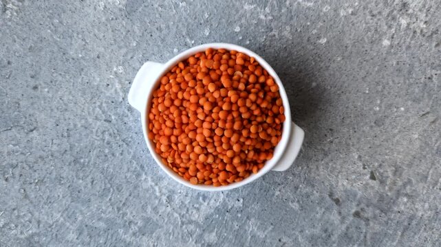 Raw red lentils as a source of protein for a healthy vegan meal. Red lentils as a food background for your design