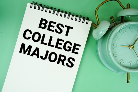 Best College Majors text with alarm clock flat lay on green background