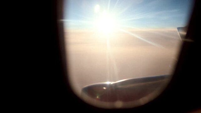Hazy Sunrise Through Airplane Window, Soft Orange Glow Over Cloud Layer, Engine Tip Catching Light, Commuter Photographer Framing Tranquil Scene, Subdued Warmth And Calm Travel Vibe