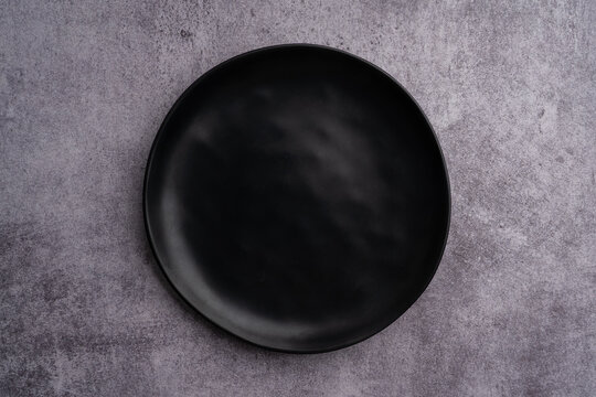 Black Rounded Ceramic Plate Marble Background
