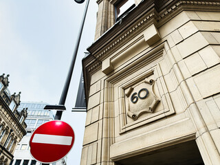 Naklejka premium Historic building corner in Manchester UK with ornate stone facade and no entry sign
