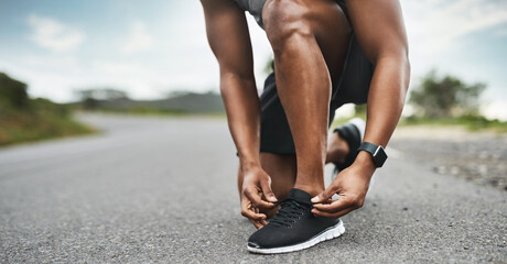 Fototapeta premium Hands, shoelace and man in city, exercise for health benefits and smart watch to track progress. Outdoor, runner and person with sneakers, fitness and practice for wellness, start day and athlete