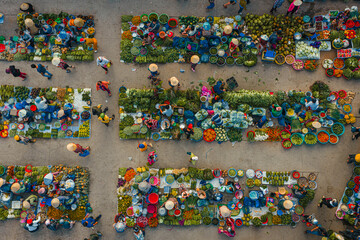 Fototapeta premium Aerial view of busy local daily life of the morning local market in Vi Thanh or Chom Hom market, Mekong Delta, Vietnam.