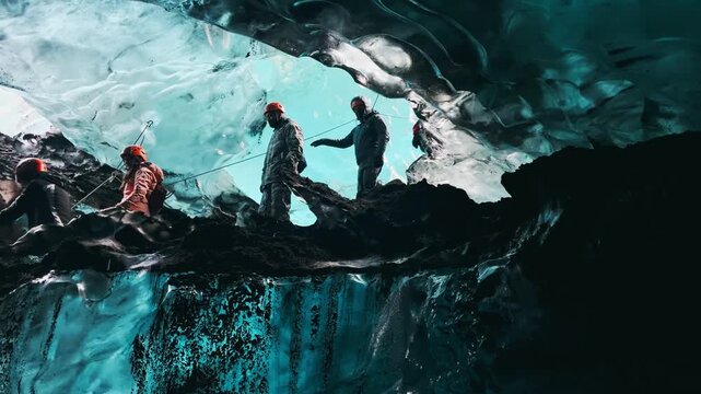Science expedition of people exploring Blue crystal ice cave in Vatnajkull glacier in Iceland