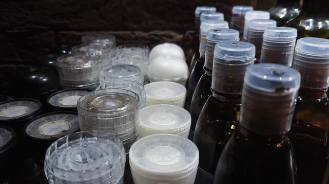 A cafe or restaurant tabletop dressings setup with various sauce bottles and a salt and pepper shakers