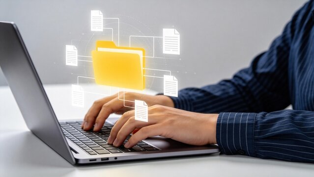 Businessperson typing on laptop with glowing digital folder interface,document management system and cloud data organization concept for enterprise workflow