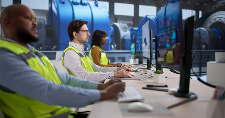 An Engineer And Technician Monitor Computer Systems Controlling Energy
