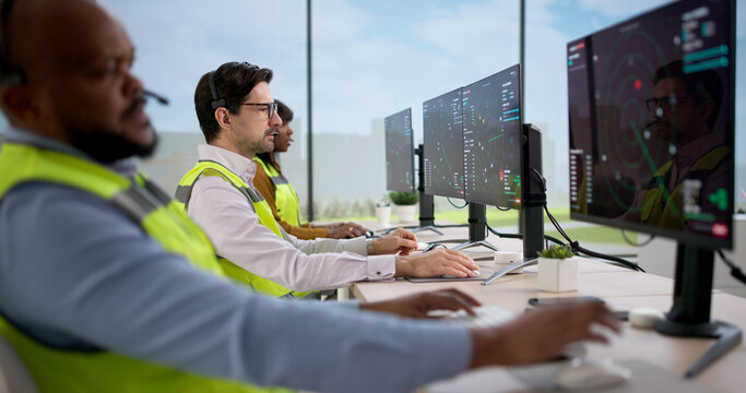 Diverse Air Traffic Control Team Monitors Flights Using Computers In Tower