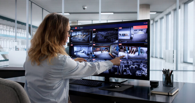 Female Security Guard Monitoring Surveillance Video