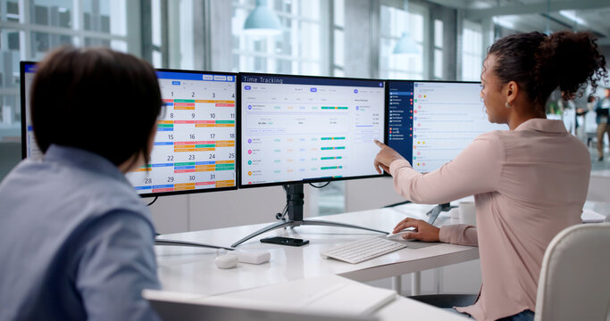 Two African American HR Managers Using Time Tracking Software
