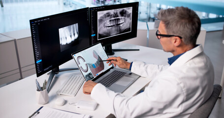 Skilled Dentist Uses Digital 3D Imaging Technology © Andrey Popov