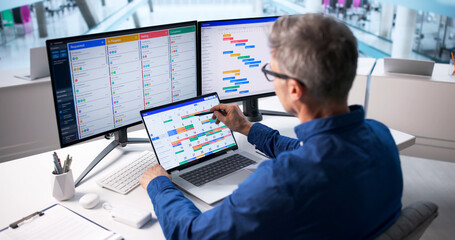 Older Caucasian Man Manages Business Event Scheduling Software