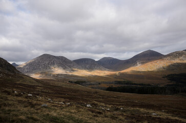 Majestic mountain valley with dramatic cloud shadows