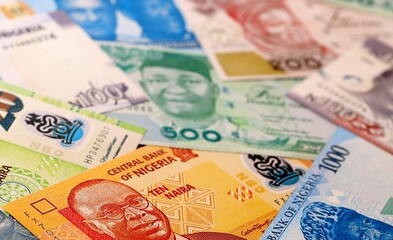 Obraz premium Nigeria naira money bills pile on table. Nigeria banknotes of NGN currency close up.