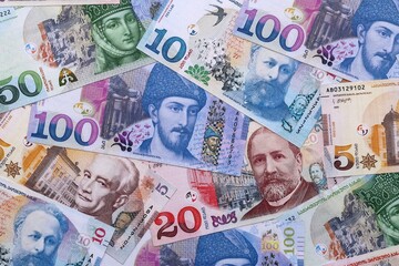 Obraz premium Georgian lari money bills pile on table. Georgia banknotes of GEL currency close up.