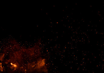 The black background shows fire in the foreground, surrounded by numerous sparks. © Arteekom
