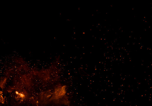 The black background shows fire in the foreground, surrounded by numerous sparks.