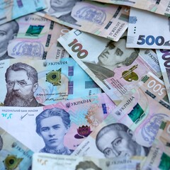 Ukrainian hryvnia money bills pile on table. Ukraine banknotes of UAH currency close up.