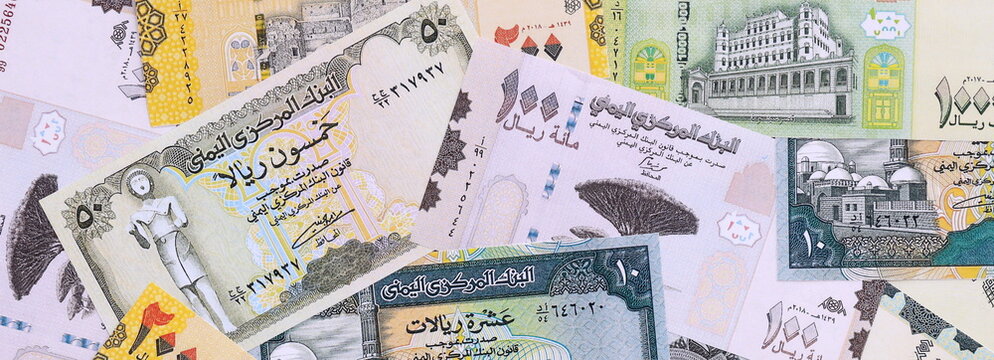 Yemeni rial money bills pile on table. Yemen banknotes of YER currency close up.