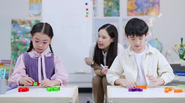 Teacher Guides Children Using Colorful Math Blocks in Classroom