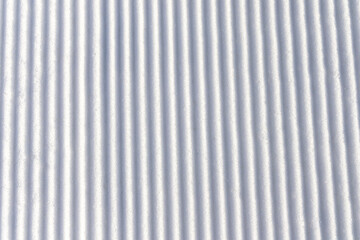 Obraz premium Snow groomed by a snowcat on a ski slope. Poland. Snow background.