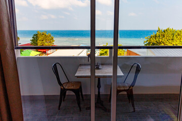 Fototapeta premium Sunlit balcony overlooks turquoise sea