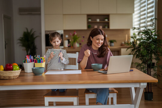 Mother and daughter balancing remote work and family life