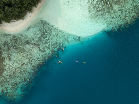 Aerial view of the turquoise waters meeting the white sandy beach of Menjangan Kecil Island creating a stunning contrast, Karimunjawa, Central Java, Indonesia.