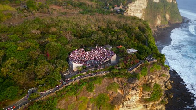 Aerial video of Kecak dance show at Uluwatu temple on cliff above ocean in Bali. High quality 4k footage
