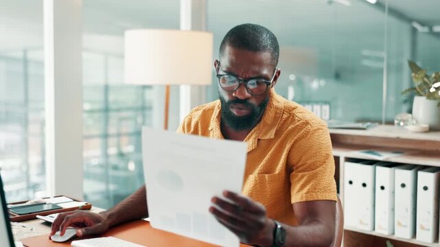 Black man, computer and documents with review at office for typing, confused or glasses at media company. Person, pc and admin with stress, check and search for project management at creative agency