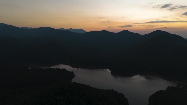 Fly over Mae Pha Haen Lake at evening, view of mountains and colorful sky