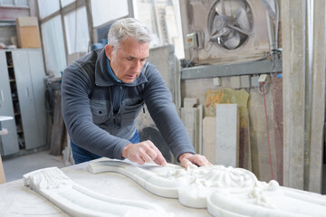 senior man working on plaster cornice © auremar