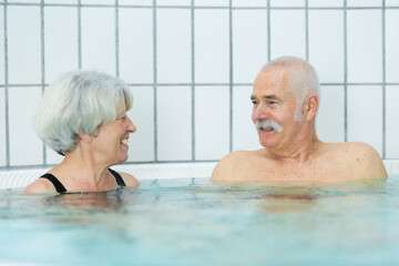 Fototapeta premium couple of seniors enjoys the pool and retirement