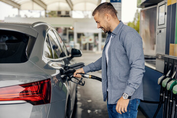 Man refueling car at gas station pump