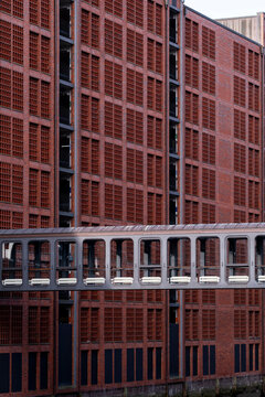 Modern urban red brick facade architecture with grid windows creating strong geometry pattern texture for abstract background and graphic design use