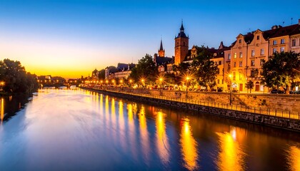 Fototapeta premium Cityscape at twilight with water reflecting city lights; old-style buildings illuminated against a colorful sky