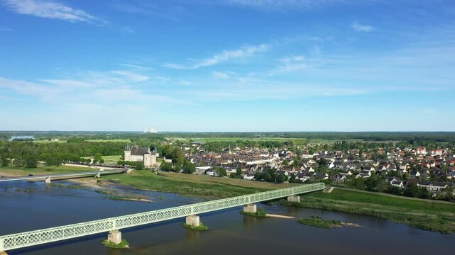 Scenic aerial shot of Sully sur Loire with its historic castle, picturesque town, and the Loire River under a clear blue sky.