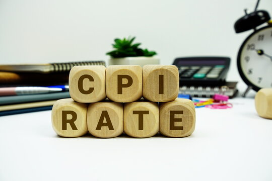 CPI Rate alphabet letters with calculator and alarm clock on white background