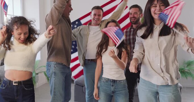 Young people group celebrate USA flag independence. Cheerful friends wave american flags, smiling in a patriotic party that radiates unity. Independence Day celebration and patriotism concept.