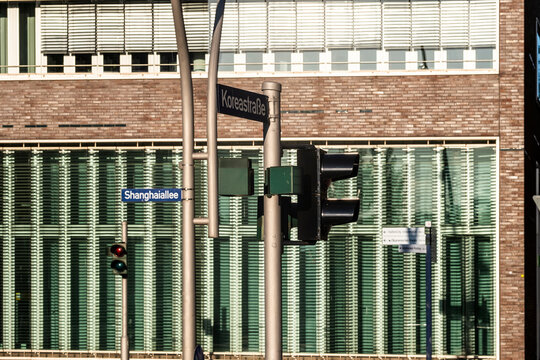 Brick building facade with windows at an urban street intersection featuring signal in daylight showing infrastructure and city traffic control with clean architectural texture
