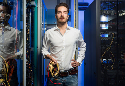 Administrator in server room holding network cables in the Netherlands