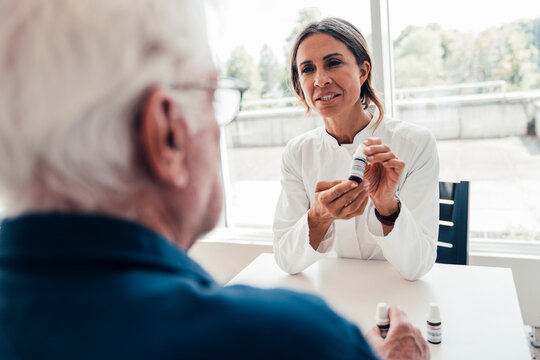 Doctor explaining homeopathic remedy to patient during consultation
