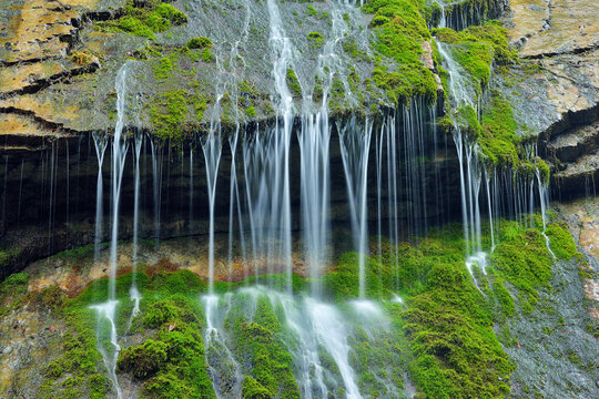 Waterfall cascading over mossy rocks at Wimbachklamm in Bavaria Germany