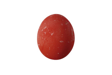 Red egg sits on a white background showing texture and color details in a simple setting