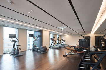 Modern fitness center interior with exercise equipment, empty gym.
