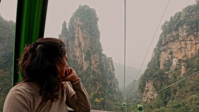 Woman riding a cable car in Zhangjiajie National Forest Park