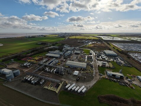 Aerial view of industrial buildings casting long shadows under a bright sky, BOC Gases, Grimsby, United Kingdom.